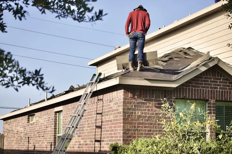 Professional roofer working on a residential roof in Emerald